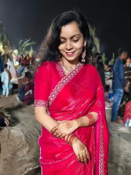 The serene smile of a client during Chhath Puja, her hands adorned with simple yet beautiful henna.