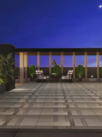Another angle from our 3D design portfolio, showcasing a spacious terrace with multiple seating areas and planters, all under a clear night sky.
