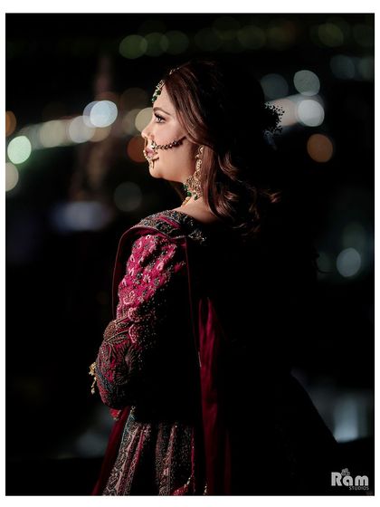 A beautiful night-time portrait of the bride, with the city lights in the background creating a lovely bokeh effect.