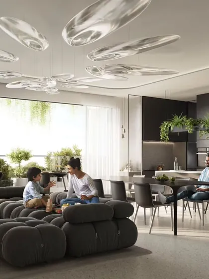 The living room of a Sky Gardens apartment, featuring modern furniture and a direct view of the lush balcony and the neighboring green tower.