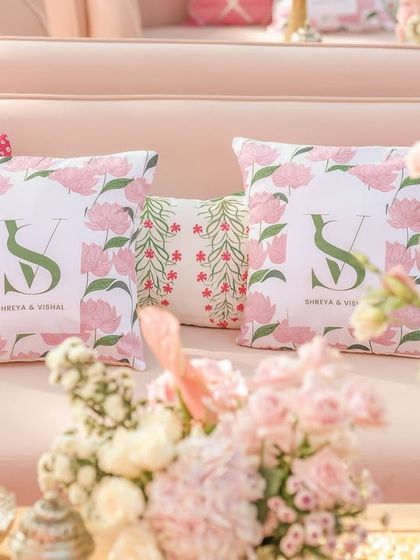 The seating areas were personalized with custom-printed cushions featuring the couple's monogram and Pichwai-inspired botanical patterns.