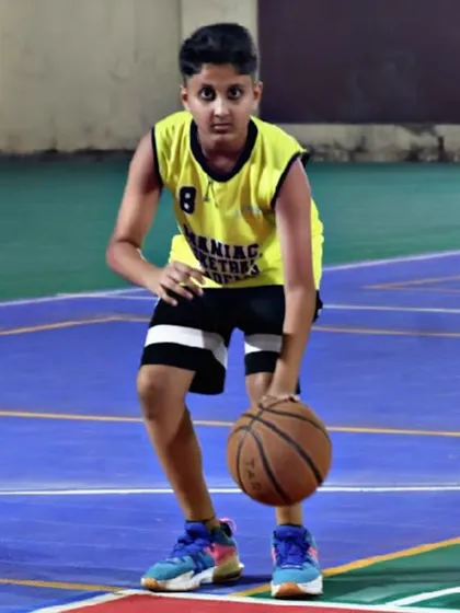 A young player with a focused look, ready to take on a dribbling drill. Our training is about transformation, turning passion into purpose.