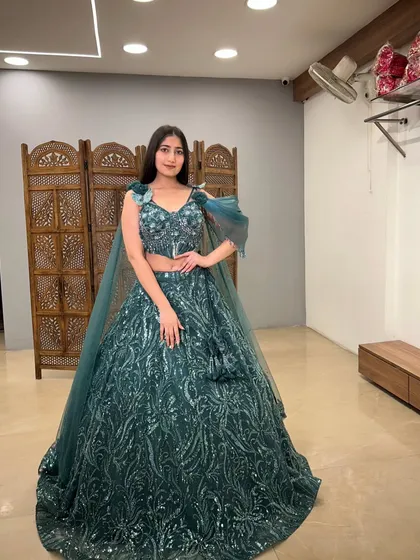 A confident pose in this stunning teal gown, perfect for a reception or cocktail event.