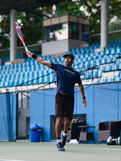 The ready position is everything in tennis. This photo shows the athletic stance required to react quickly and move explosively to either side of the court.