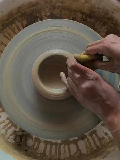 Molded from the earth, shaped by the soul. This image captures the moment of creation on the wheel, a symphony of texture and tone as the form takes shape.