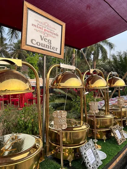 Another angle of our stunning veg counter at an outdoor event. The combination of traditional brass-finished serveware and natural elements creates a look of rustic luxury.