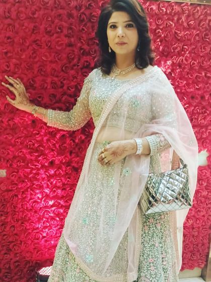 This client has paired the mint green rental lehenga with a stylish silver bag, showing how you can personalize your rented look.