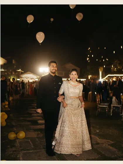 The grand entrance at their reception, walking under a sky of balloons. A moment filled with joy and celebration.