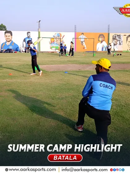 A coach observes a practice session at the summer camp, with murals of sporting legends providing inspiration.
