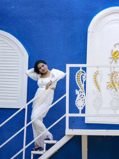 A fashionable shot on a white staircase against a bold blue wall. This shows the versatility of our sets for all types of photoshoots.