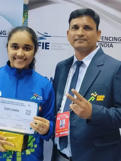 Our coach celebrates with a student fencer at the FIE Women's Satellite Tournament. We are there every step of the way, providing mentorship and support during high stakes competitions.