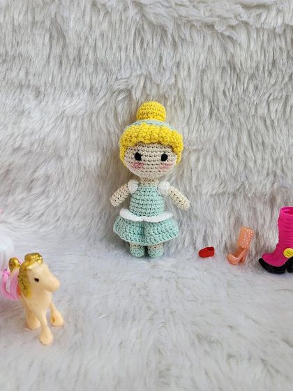 The classic Disney princess, Cinderella. She is dressed in her beautiful light blue ball gown with her hair in a neat bun, ready for the royal ball.