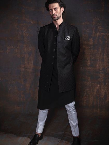 Step into sophistication with my luxury Indo-Western collection. This black asymmetrical jacket paired with contrasting white trousers is a bold and modern statement.