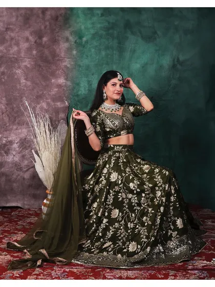 Elegance captured in a single frame. This portrait showcases a stunning traditional lehenga, where we used a painterly backdrop and soft lighting to highlight the intricate details of the fabric and jewelry.