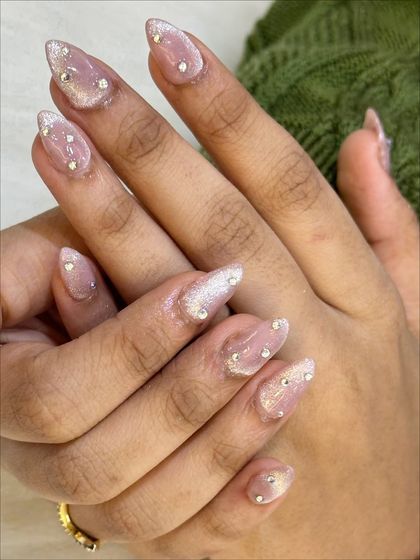 A close-up shot of the cat eye nails, showing the detail of the stone placement and the magnetic shimmer.