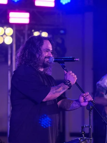 A candid shot of our frontman smiling while performing. We genuinely have a blast at every show, and that joy is infectious.