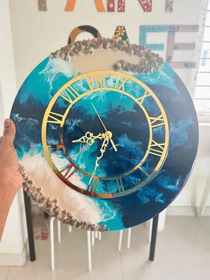 This is an example of a finished epoxy resin clock from one of our workshops. Participants learn to mix pigments and pour resin to create a stunning, functional piece of art with a glossy, professional finish.