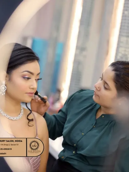 Another shot of the makeup application process, seen through a ring light. I take great care in ensuring every detail is perfect for your special occasion.