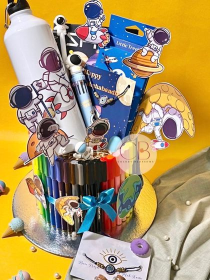 Our "To The Moon" Rakhi stationery hamper is perfect for young siblings. It's a creative arrangement of sketch pens, a diary, colour pencils, a keychain, erasers, a sipper bottle, and an evil eye rakhi.