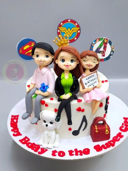 A "Super Girl" mom cake with the whole family represented as fondant figurines, including the family dog.