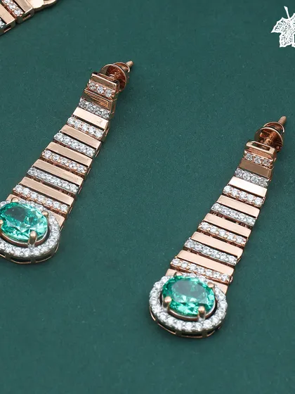 The Emerald Glow earrings, a perfect match to the statement necklace.