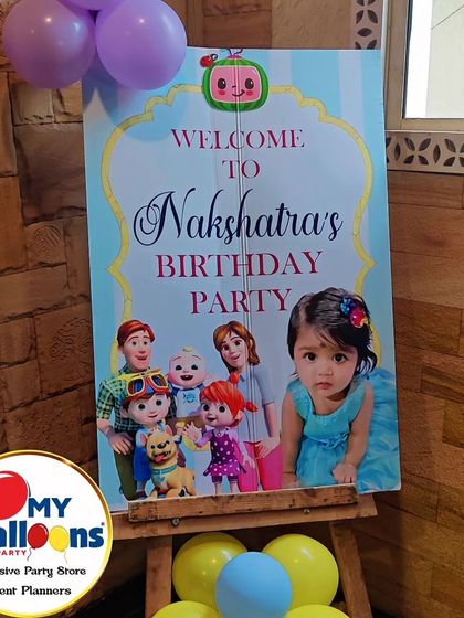 A personalized welcome sign for a Cocomelon-themed first birthday, featuring a photo of the birthday girl.