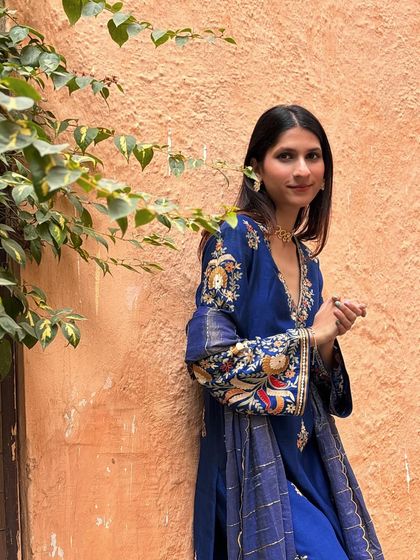 A close-up showing the detailed embroidery on the sleeves. I help clients find pieces with unique artisanal details that make them stand out.