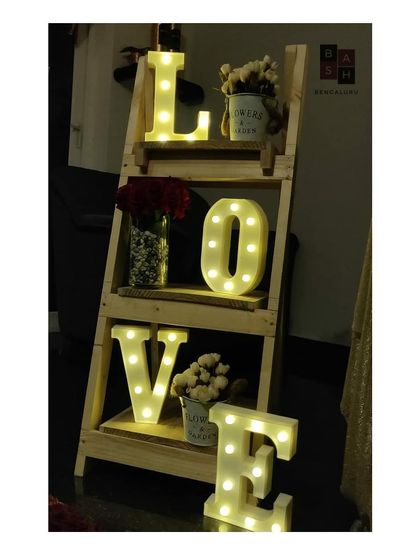This decorative ladder shelf is a unique way we display marquee letters and floral arrangements. It adds height and visual interest to a room corner, turning it into a charming and personalized decor piece for a date night.