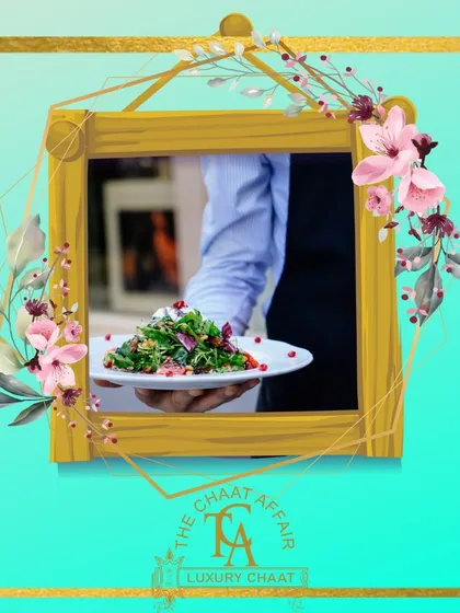 A server presents a plate of our Palak Patta Chaat. This fusion dish features crispy spinach leaves topped with yogurt, chutneys, and spices, offering a unique and delicious twist on traditional chaat.