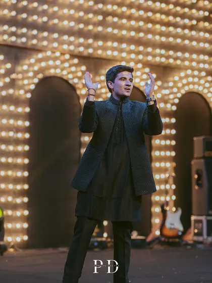 The groom's performance on a stage featuring a backdrop of vintage-style marquee lights. This design adds a touch of old-school glamour and makes for a fantastic performance setting.