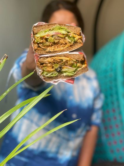 Here's another look at our Vietnamese BBQ Chicken Sandwich, held up for you to see all the delicious layers. It's a wholesome and flavorful option that's perfect for a satisfying Sunday meal.