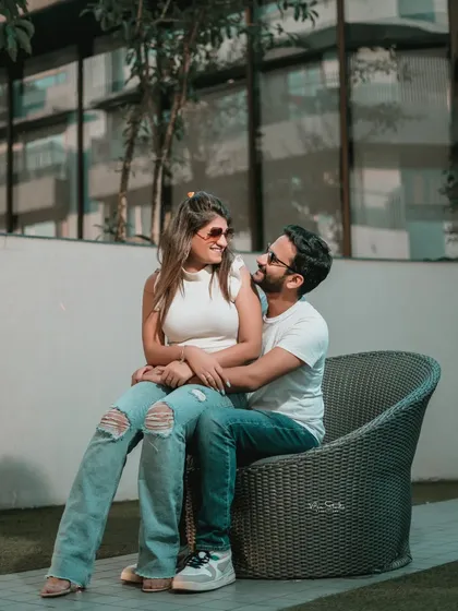 A beautiful, interactive portrait where the couple is lost in their own world. The genuine smiles and eye contact make this photo feel incredibly personal and real.
