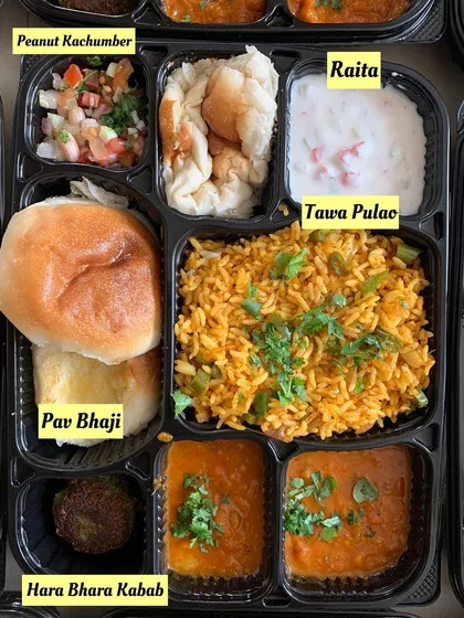 A detailed view of the office party meal tray, including Pav Bhaji, Tawa Pulao, and Hara Bhara Kabab.