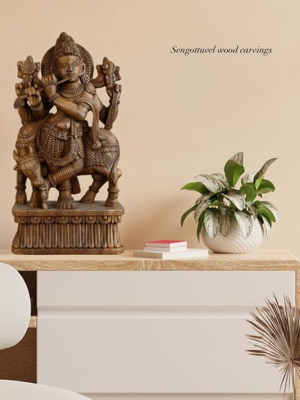 Our 24-inch Lord Krishna statue with a classic brown finish, shown here as an elegant decor piece on a modern console table. It demonstrates how our traditional art can elevate contemporary interiors.