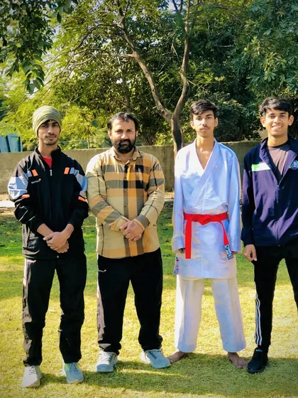 One of my senior red belt students with the coaching staff. He is a leader and role model in the dojo.