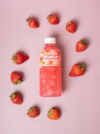 A strawberry-flavored drink shot from above, encircled by fresh strawberries. This simple and graphic composition is clean, modern, and highly effective.