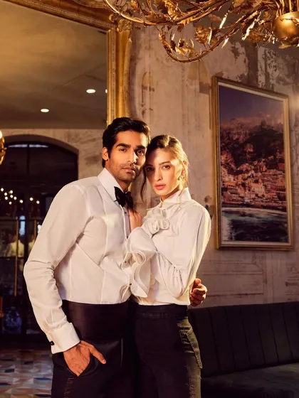 A sophisticated couple shot for Camessi Collections. The warm, ambient lighting of the luxurious location complements the classic elegance of the formal wear.