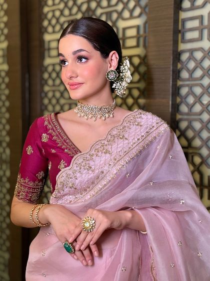 A beautiful Karwa Chauth look featuring a soft pink organza saree with a contrasting magenta blouse. This is how you celebrate tradition with modern elegance.
