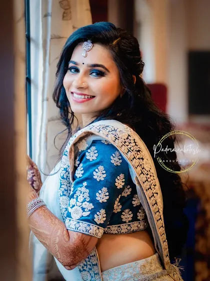 For a reception, we can go for full glam. This bride wanted a captivating look, so I created a dramatic blue smokey eye, balanced with soft contouring and a neutral lip, ensuring she looked stunning all night long.