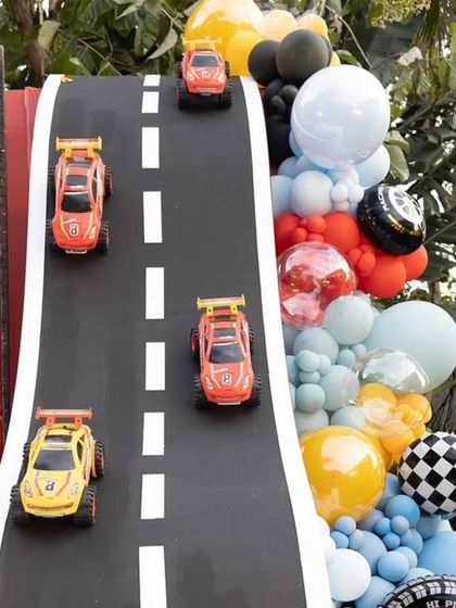Detail shot of the toy cars on the custom-built race track prop.