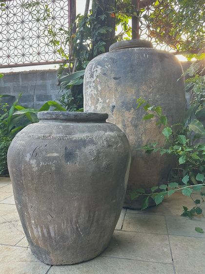 A pair of my vintage pots, showing how their grand size and unique, time-worn patina can anchor a garden space.