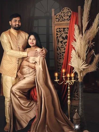 Wrapped in love, draped in tradition. This couple looks regal in coordinated golden outfits, creating a warm and luxurious traditional maternity portrait.
