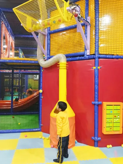 A student interacts with our ball vacuum and basket system, a fascinating feature that demonstrates simple physics in a playful way.