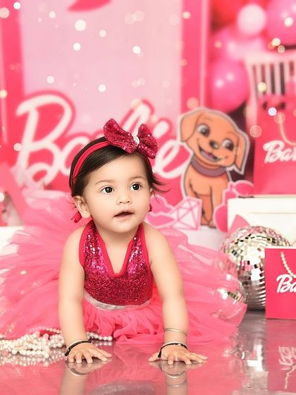 A glamorous Barbie-themed shoot for a little doll. The explosion of pink, pearls, and shopping bags creates a fun and stylish atmosphere.