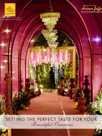 The entrance to your event should be as magical as the celebration itself. This stunning arched entryway, adorned with pink floral arrangements and illuminated by grand chandeliers, creates a perfect and welcoming first impression for your guests.