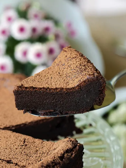 A close-up of a slice of my Gluten-Free Dark Chocolate Cake, showcasing its dense and fudgy texture.