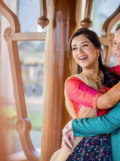 A candid moment of a couple sharing a laugh. The natural, unposed nature of this shot highlights their genuine happiness and comfortable connection.