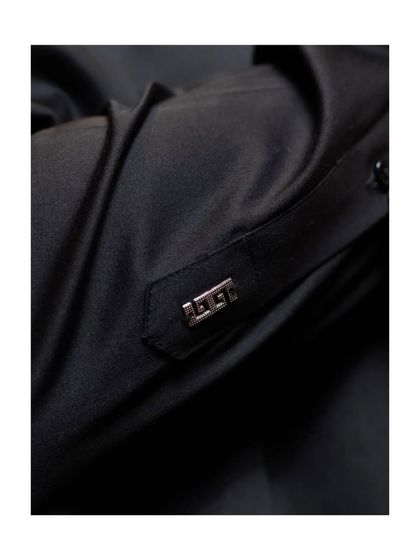 A close-up of the cuff detail. This metallic accent on the sleeve tab is another example of how we incorporate unique, contemporary elements into our traditional wear.