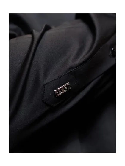 A close-up of the cuff detail. This metallic accent on the sleeve tab is another example of how we incorporate unique, contemporary elements into our traditional wear.