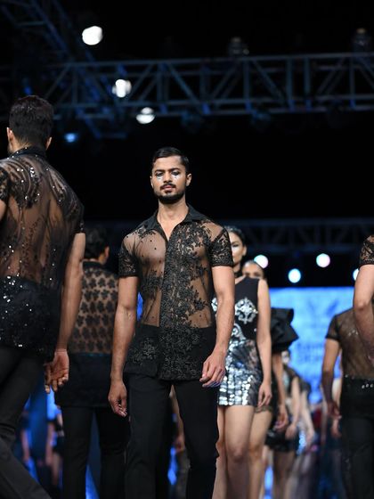 A dynamic shot from the finale walk at Mysore Fashion Week, surrounded by other models.